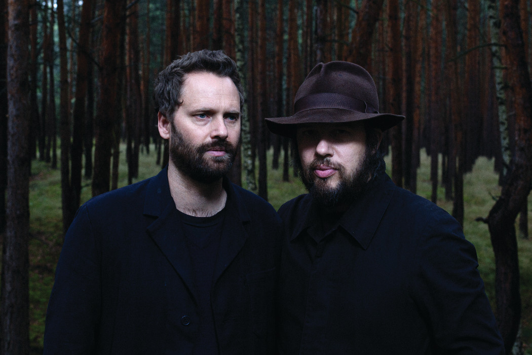 A Winged Victory For The Sullen by Nick and Chloe, two men dressed in black stood in a dark forest