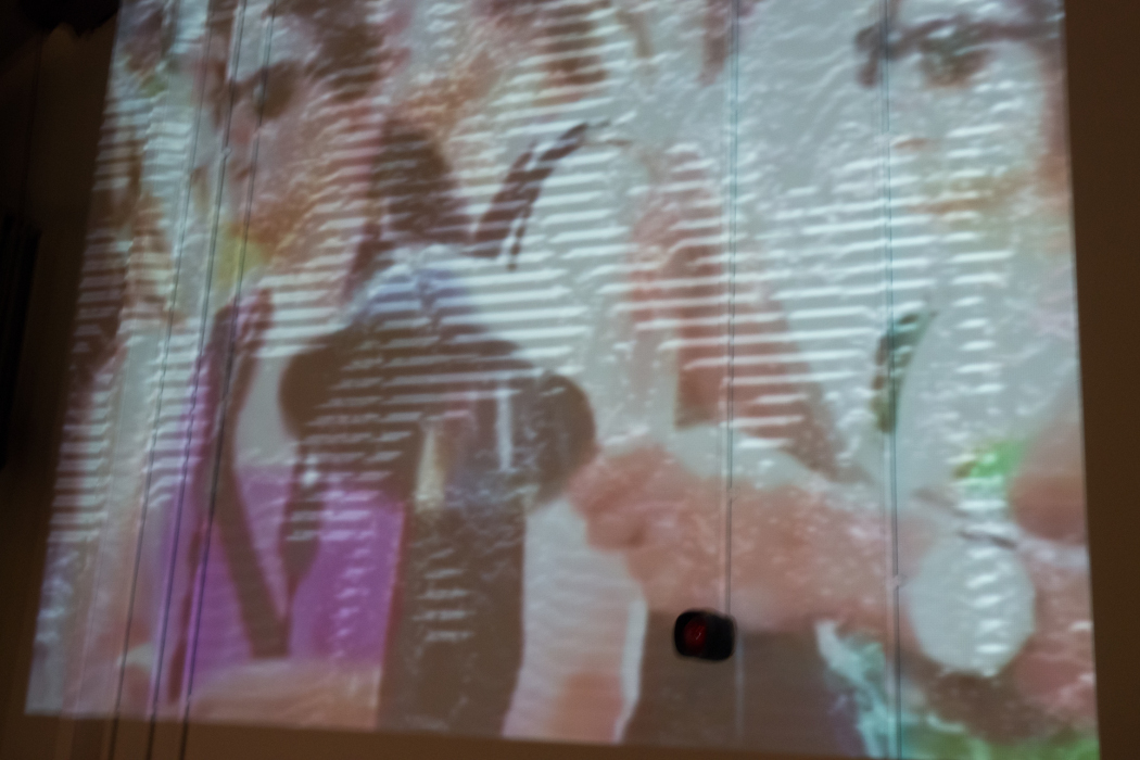LaptopsRus at Network Music Festival 2014, video projection of women beating pans in a street protest