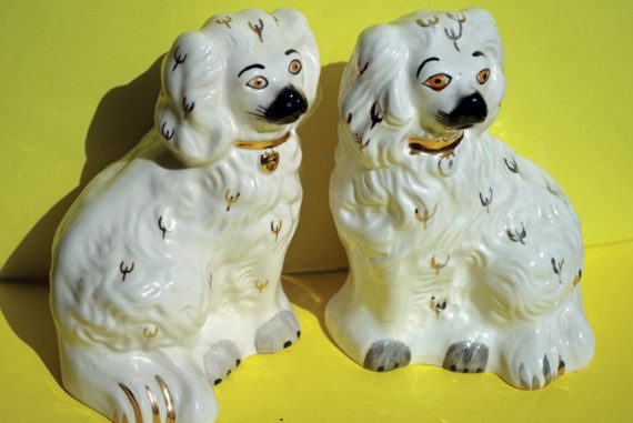 Angharad Davies and Tisha Mukarji - ffansïon fancies, two white china dogs against a bright yellow background
