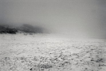 Sergio Merce - be nothing, black and white image of an empty beach covered in haze