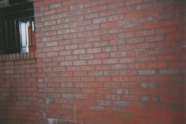 Brick Wall, photo of a red brick wall reflecting sunlight