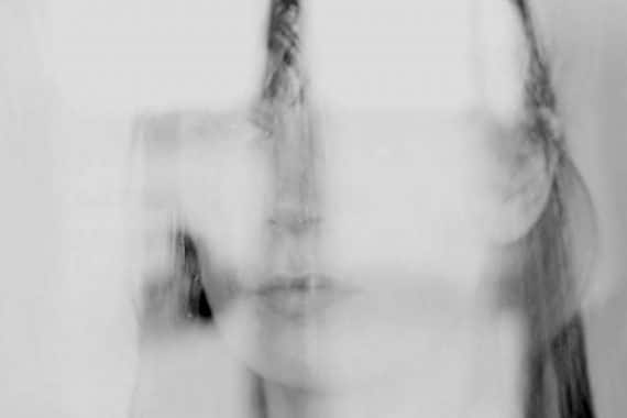 Jana Irmert - End of Absence, vague impression of artist's face reflected in glass