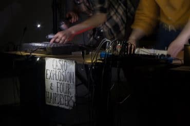 Kinder Meccano - table with mixing desk and Tascam PortaStudio, hands of performers