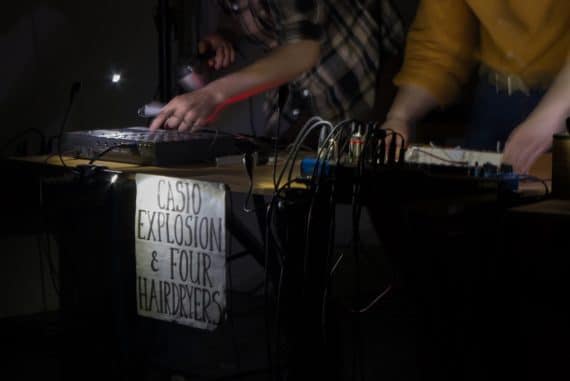 Kinder Meccano - table with mixing desk and Tascam PortaStudio, hands of performers