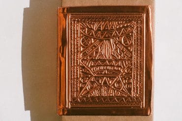 diatribes - Sistere, intricate copper metalwork design depicting a face