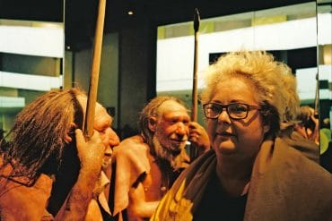Maria de Alvear - besando el tiempo, composer stood next to two Neanderthal wax models with spears at the Neanderthal museum