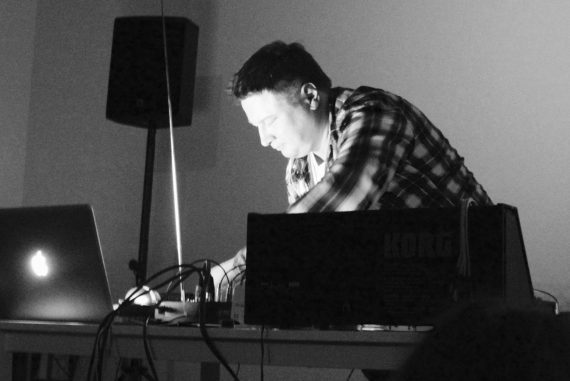 Photo of Kurt Leidwart performing with synthesizer and laptop.