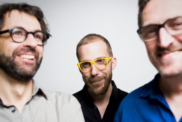 Ensemble 0 - 0=12, the three permanent members of the ensemble against a light background